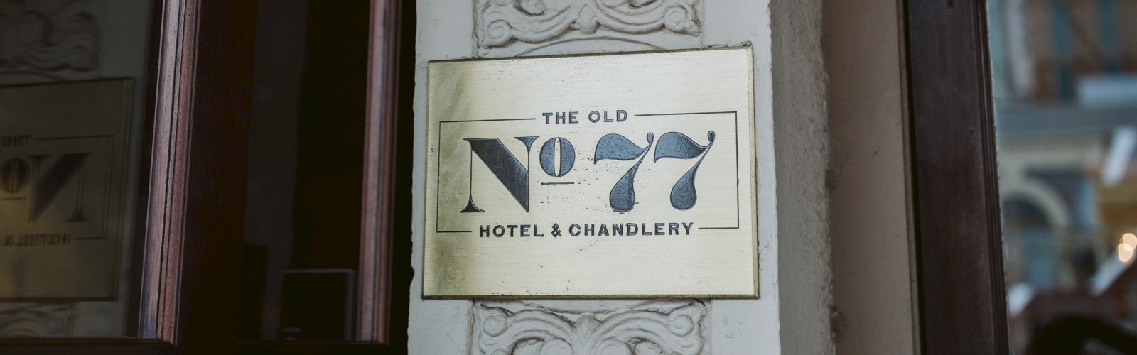 A vintage lantern hangs above a plaque that reads 