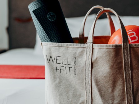 A beige tote bag labeled 