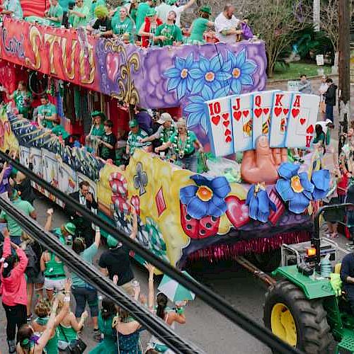 A lively parade with a colorful float, people waving, and a joyful crowd on