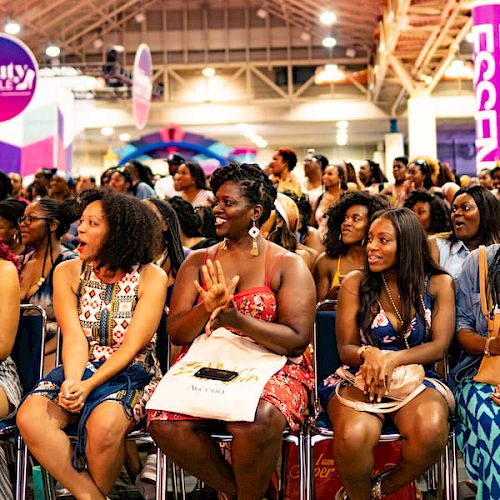 A group of attentive people sitting at an event, possibly a conference or seminar.