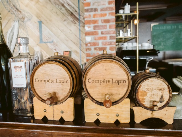 The image shows three wooden barrels labeled 